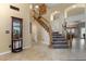 Wood staircase with carpet runner and view into dining area at 6210 W Foothill Dr, Glendale, AZ 85310