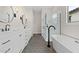 Elegant bathroom featuring double vanity, soaking tub, and glass shower at 671 E Greenback Dr, San Tan Valley, AZ 85140