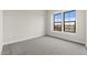 Empty bedroom with grey carpet and large window at 671 E Greenback Dr, San Tan Valley, AZ 85140