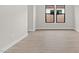 Simple bedroom with wood-look tile flooring and windows at 671 E Greenback Dr, San Tan Valley, AZ 85140