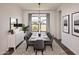 Elegant dining room with large windows and seating for six at 671 E Greenback Dr, San Tan Valley, AZ 85140