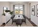 Elegant dining room with large windows and seating for six at 671 E Greenback Dr, San Tan Valley, AZ 85140