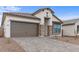 Craftsman style home with a two-car garage and stone accents at 671 E Greenback Dr, San Tan Valley, AZ 85140