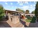 Outdoor kitchen with built-in grill and patio seating at 7529 E Windsor Ave, Scottsdale, AZ 85257