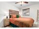 Bedroom with orange bedding, geometric headboard, and wood nightstand at 7529 E Windsor Ave, Scottsdale, AZ 85257