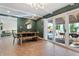 Modern dining area with a green wall and access to the backyard patio at 7529 E Windsor Ave, Scottsdale, AZ 85257