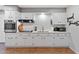 White kitchen with stainless steel appliances and herringbone backsplash at 7529 E Windsor Ave, Scottsdale, AZ 85257