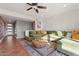 Open living room with sectional sofa, coffee table, and a view of the entryway at 7529 E Windsor Ave, Scottsdale, AZ 85257