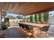 Outdoor patio with dining table, chairs, and a covered area at 7529 E Windsor Ave, Scottsdale, AZ 85257