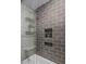 Modern bathroom with gray tile shower and built-in shelves at 8227 E Hubbell St, Scottsdale, AZ 85257