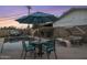 Enjoy Alfresco dining by the pool with comfortable seating and umbrella at 8227 E Hubbell St, Scottsdale, AZ 85257