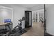 Home gym with Peloton bike and view into kitchen at 840 W Earll Dr, Phoenix, AZ 85013