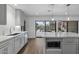 Modern kitchen with marble countertops and gray cabinets at 840 W Earll Dr, Phoenix, AZ 85013