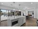 Kitchen with marble island, gray cabinets & view of the backyard at 840 W Earll Dr, Phoenix, AZ 85013