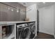 Laundry room with stacked washer and dryer, plus storage at 840 W Earll Dr, Phoenix, AZ 85013