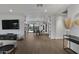 Bright living room with grey sectional sofa and wood-look floors at 840 W Earll Dr, Phoenix, AZ 85013