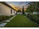 Landscaped backyard with artificial turf and stone pathway at 8400 E Columbus Ave, Scottsdale, AZ 85251