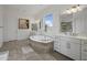 Bathroom with soaking tub, double vanity, and view into bedroom at 8400 E Columbus Ave, Scottsdale, AZ 85251