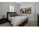 Guest bedroom with a queen-size bed and dark brown furniture at 8400 E Columbus Ave, Scottsdale, AZ 85251