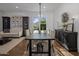 Elegant dining room with dark wood table and cabinetry, hardwood floors, and a living area at 8400 E Columbus Ave, Scottsdale, AZ 85251