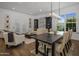 Bright dining room features a large wooden table, hardwood floors, and adjacent living area at 8400 E Columbus Ave, Scottsdale, AZ 85251