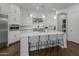 Modern kitchen with white cabinets, large island, and stainless steel appliances at 8400 E Columbus Ave, Scottsdale, AZ 85251