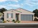 One-story home with gray garage door and landscaping at 8656 W Warner St, Tolleson, AZ 85353