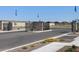 The entrance to the community is a metal gate flanked by stone pillars and desert landscaping at 9108 N 174Th Ln, Waddell, AZ 85355