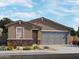 New home exterior with stone accents and gray garage door at 9108 N 174Th Ln, Waddell, AZ 85355