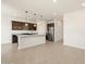 A modern kitchen with an island, stainless steel appliances, and tile floors at 9108 N 174Th Ln, Waddell, AZ 85355