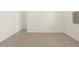 An empty living room with neutral colored tile floors and white walls at 9108 N 174Th Ln, Waddell, AZ 85355