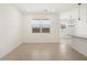 A living room with neutral colored tile floors, white walls, and a modern chandelier at 9108 N 174Th Ln, Waddell, AZ 85355