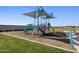 Colorful community playground with climbing structures, slides, and a protective mulch base at 9108 N 174Th Ln, Waddell, AZ 85355