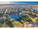 Aerial view of a community with a lake and golf course at 9754 E Natal Ave, Mesa, AZ 85209