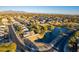 Aerial view of homes, a pond and golf course at 9754 E Natal Ave, Mesa, AZ 85209