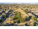 Aerial view of a community near a golf course and mountains at 9754 E Natal Ave, Mesa, AZ 85209