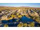 Aerial view showing a pond and houses near a golf course at 9754 E Natal Ave, Mesa, AZ 85209