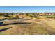 Aerial view of a golf course with a winding path at 9754 E Natal Ave, Mesa, AZ 85209