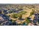 Aerial view highlighting homes surrounding a golf course at 9754 E Natal Ave, Mesa, AZ 85209