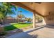 Landscaped backyard with a sparkling pool and artificial turf at 9754 E Natal Ave, Mesa, AZ 85209