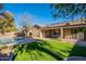 Landscaped backyard with a covered patio and pool at 9754 E Natal Ave, Mesa, AZ 85209