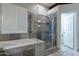 Elegant bathroom with a large glass shower, soaking tub, and updated fixtures at 9754 E Natal Ave, Mesa, AZ 85209