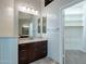 Bathroom with dark brown vanity and walk-in closet at 9754 E Natal Ave, Mesa, AZ 85209