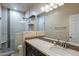 Bathroom with a walk-in shower, tiled walls, and modern vanity at 9754 E Natal Ave, Mesa, AZ 85209