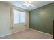 Bedroom with window, ceiling fan, and neutral wall colors at 9754 E Natal Ave, Mesa, AZ 85209