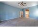 Blue-walled bedroom with ceiling fan and en-suite bathroom at 9754 E Natal Ave, Mesa, AZ 85209