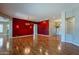 Open dining area with hardwood floors and red accent wall at 9754 E Natal Ave, Mesa, AZ 85209