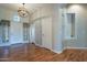 Bright entryway with wood floors, neutral walls, and a charming chandelier at 9754 E Natal Ave, Mesa, AZ 85209