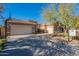 Single story home with a two-car garage and basketball court at 9754 E Natal Ave, Mesa, AZ 85209