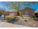 House exterior with a two-car garage and drought-tolerant landscaping at 9754 E Natal Ave, Mesa, AZ 85209